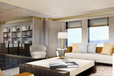 This luxurious living room offers stunning water views through expansive windows, complemented by elegant furnishings and built-in shelving.