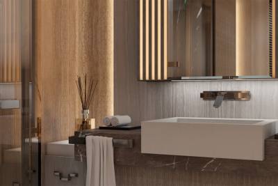 A modern bathroom features a sleek white sink, a chrome faucet, and warm wood accents illuminated by soft lighting.