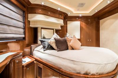 Luxurious yacht interiors feature plush bedding and rich wood accents for ultimate comfort and style.