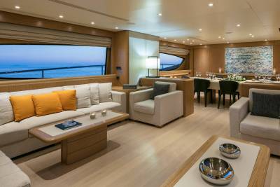 Luxurious yacht interiors offer a serene setting for dining and relaxation with stunning ocean views.