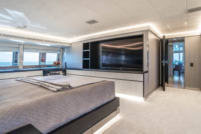 Luxurious yacht master suite offers stunning ocean views and modern entertainment.