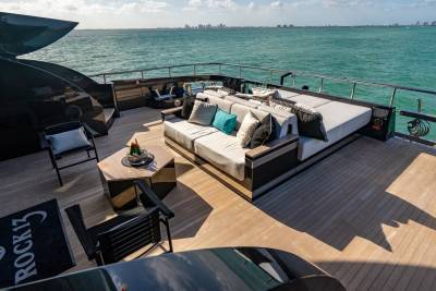 Relax on the spacious deck of this luxurious yacht, complete with plush seating and stunning ocean views.