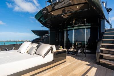 Luxurious outdoor seating and sleek black accents define the deck of this modern yacht.