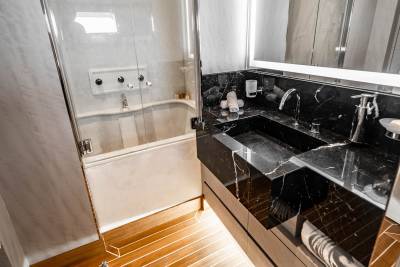 Luxurious marble countertops and a sleek bathtub create an opulent sanctuary in this modern yacht bathroom.