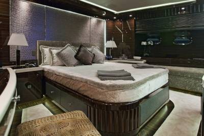 Luxurious dark wood paneling and plush furnishings create an opulent retreat aboard this private yacht.