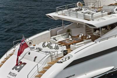 The luxurious yacht "Rush" glides through the deep blue sea, offering a serene and opulent escape.