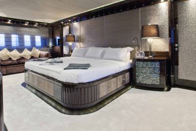 Luxurious yacht interiors feature a plush king-sized bed, elegant seating, and ambient lighting for ultimate comfort.