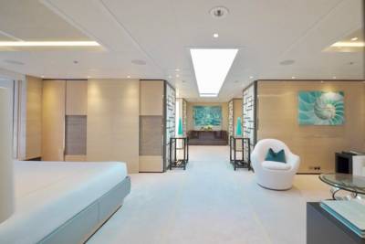 Luxurious yacht interiors feature minimalist design with natural wood accents and striking nautical artwork.