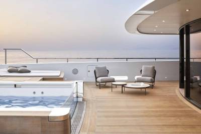 Relax in the luxurious jacuzzi or lounge on the deck of this elegant yacht as the sun sets over the tranquil ocean.