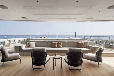 Relax on the spacious deck of this luxurious yacht, enjoying the serene ocean views and comfortable seating.