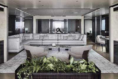Luxurious yacht interiors feature a spacious, modern living area with plush seating and elegant decor.
