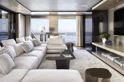 Luxurious yacht interiors offer breathtaking ocean views through expansive windows and comfortable seating arrangements.
