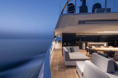 Luxurious yacht deck seating and dining areas offer a serene escape on the tranquil twilight sea.