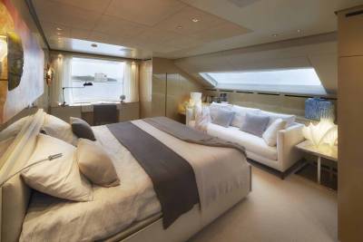 Luxurious yacht accommodations offer a serene retreat with ocean views and elegant furnishings.