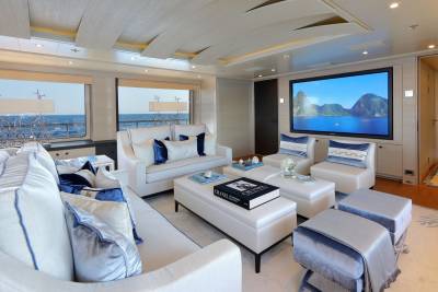 Luxurious yacht salon offers stunning ocean views and a large screen for entertainment.