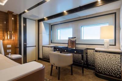 Luxurious yacht interiors feature elegant furnishings, modern lighting, and expansive windows offering stunning ocean views.