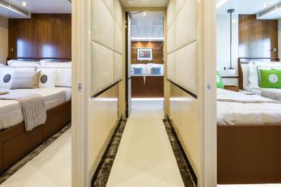 Luxurious cabins with plush bedding and elegant wood accents offer a serene retreat aboard this opulent yacht.