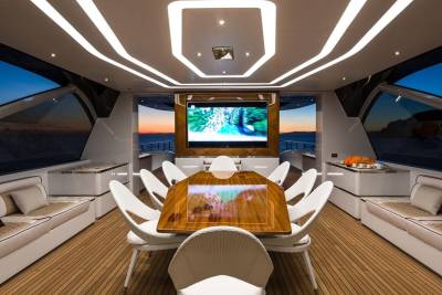 Experience luxurious al fresco dining and entertainment aboard this stunning yacht as the sun sets over the ocean.
