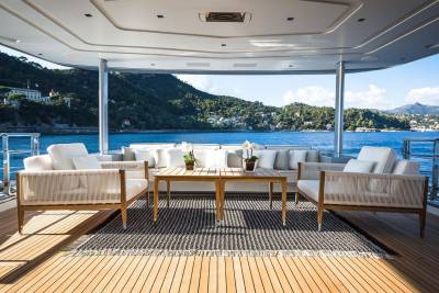 Relax on the deck of this luxurious yacht, surrounded by stunning coastal views and the tranquil blue sea.