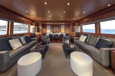 Luxurious yacht interior offers a serene dining and lounging space with panoramic ocean views.
