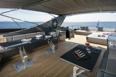 Enjoy a luxurious al fresco dining experience on the deck of this elegant yacht, surrounded by the sparkling blue sea.