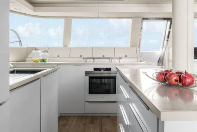 A modern yacht kitchen with a stunning ocean view offers a bright and airy space for culinary adventures.