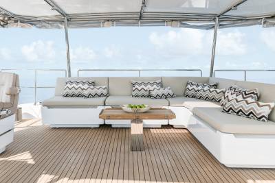 Relax on the spacious deck of this yacht, complete with comfortable seating and a beautiful ocean view.