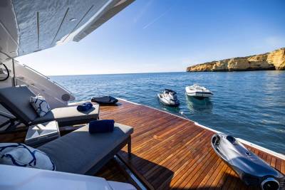 Relax on the deck of a luxury yacht with jet skis and a sea scooter ready for adventure.