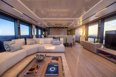 A luxurious yacht interior offers a serene living space with ocean views and elegant furnishings.