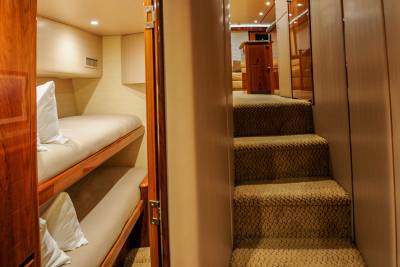 Luxurious bunk beds and a carpeted staircase create a cozy and elegant interior on this yacht.