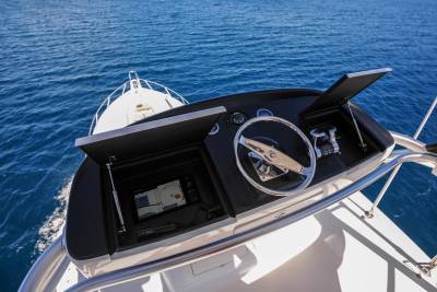 Navigate the open ocean from the helm of this sleek vessel, surrounded by the endless blue.