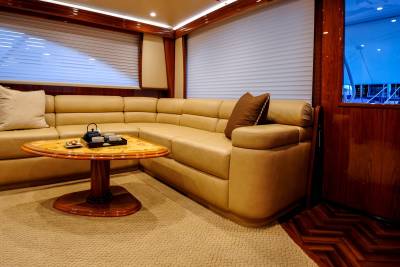 Luxurious beige leather seating and a polished wood table create an inviting lounge area on this elegant yacht.