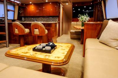 Luxurious wood finishes and plush seating create an opulent atmosphere aboard this elegant yacht.