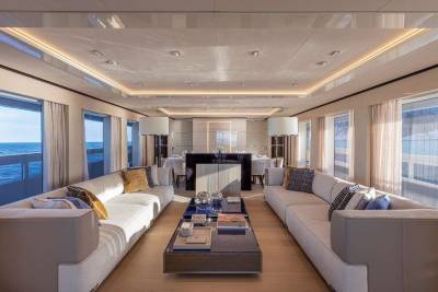 Luxurious yacht interiors offer a serene ambiance with expansive windows overlooking the tranquil ocean.