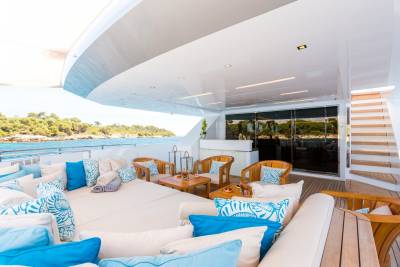 Relax on the spacious deck of this luxurious yacht, surrounded by plush cushions and breathtaking ocean views.