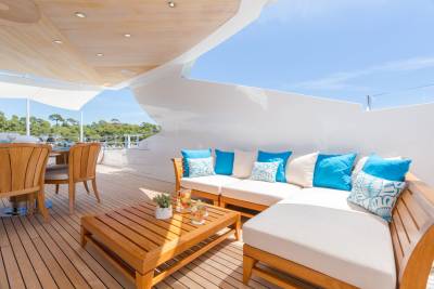 Relax on the sun-drenched deck of this luxurious yacht, surrounded by lush greenery and the sparkling blue sea.