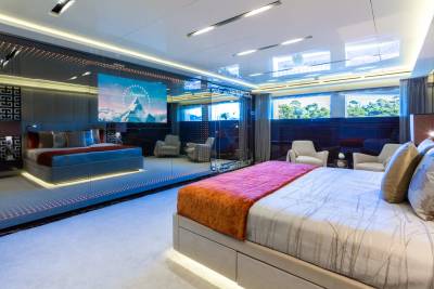 Luxurious yacht interiors offer a breathtaking view of the Paramount logo projected onto a mirrored wall above a plush bed.