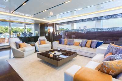 Luxurious yacht interiors feature plush seating and elegant decor, offering a serene escape with stunning ocean views.