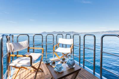Enjoy a serene breakfast with a view of the sparkling Mediterranean Sea from the deck of a luxurious yacht.