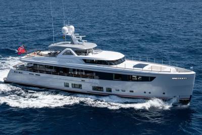 The sleek yacht Calypso glides through the deep blue ocean, leaving a foamy wake behind.