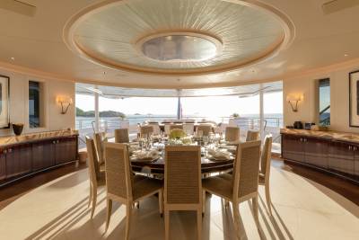 Dine in elegant style on this yacht's formal dining table, set for a feast with ocean views.