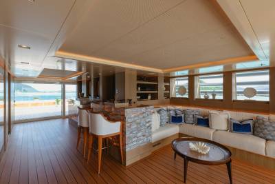 Luxurious yacht interiors blend seamlessly with breathtaking ocean views through expansive glass doors.