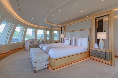 Luxurious yacht master suite offers stunning ocean views and elegant, comfortable furnishings.