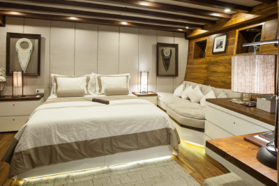 Luxurious wooden cabin offers a plush bed, cozy sofa, and elegant decor for a serene retreat.