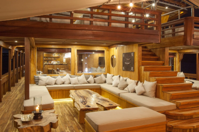 Luxurious wooden interiors and plush seating create a cozy retreat on this elegant yacht.