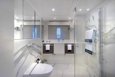 Luxurious marble and gleaming chrome create a spa-like sanctuary in this modern yacht bathroom.