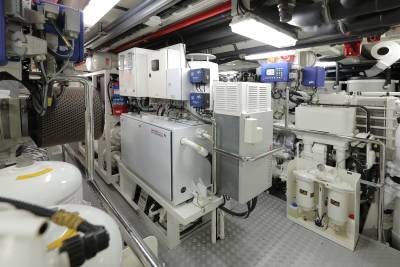 The engine room of a luxury yacht houses complex machinery, including generators and filtration systems, vital for its operation.