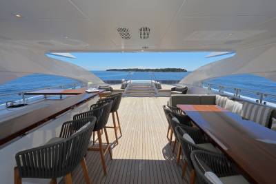 Enjoy a refreshing drink at the bar or dine al fresco on this luxurious yacht deck with a stunning ocean view.