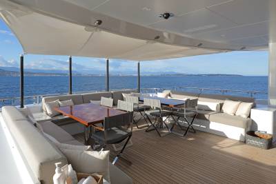Relax on the spacious deck of this luxury yacht, enjoying the stunning ocean views and comfortable seating.