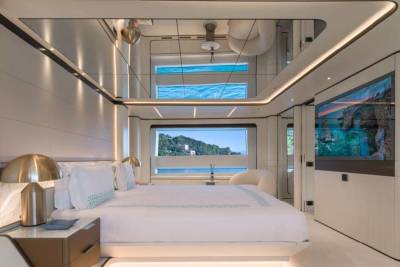 Luxurious yacht bedroom offers stunning ocean views and modern entertainment.